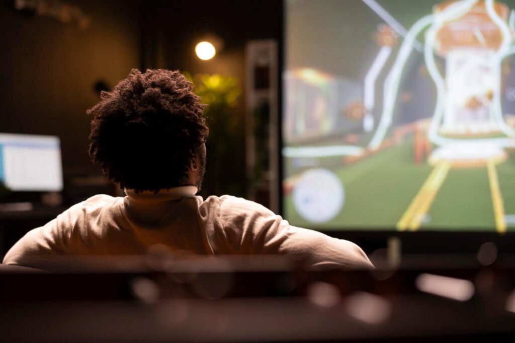 Nigerian football fan following a match on a big screen, part of the country's football and online betting culture